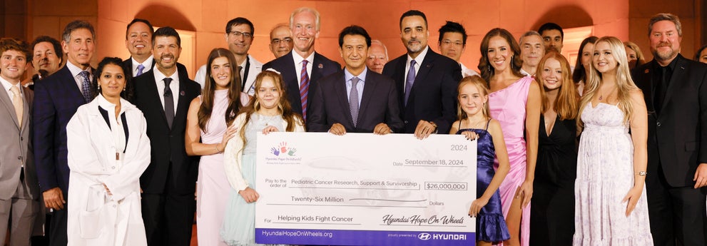 helping kids fight cancer foundation showing their big check from hyundai hope on wheels - LaFontaine Hyundai Commerce in Commerce Township MI